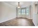 Dining room featuring luxury vinyl plank flooring, modern light fixture, and many windows at 520 White Pines Dr, Dallas, GA 30157