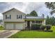 Inviting two-story home with a blue metal roof, a two-car garage, and green grass at 520 White Pines Dr, Dallas, GA 30157