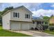 Two-story home with a blue metal roof, a two-car garage, front porch and lawn at 520 White Pines Dr, Dallas, GA 30157
