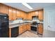 This kitchen features stainless steel appliances, wooden cabinets, and a convenient layout at 520 White Pines Dr, Dallas, GA 30157
