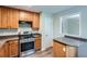 A spacious kitchen featuring stainless steel appliances, wooden cabinets and bar seating area at 520 White Pines Dr, Dallas, GA 30157