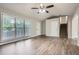 Open-concept living room with lots of natural light, luxury vinyl plank flooring, and a staircase at 520 White Pines Dr, Dallas, GA 30157
