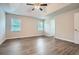 A bright primary bedroom featuring a tray ceiling, ceiling fan, and light-colored walls at 520 White Pines Dr, Dallas, GA 30157