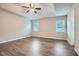 Spacious primary bedroom with ceiling fan, tray ceiling, and large windows providing natural light at 520 White Pines Dr, Dallas, GA 30157