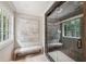 Elegant bathroom showcasing a glass shower and views of the outdoors from the vanity and shower at 5349 Forest Springs Dr, Dunwoody, GA 30338