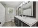 Charming bathroom with double sink vanity, sleek mosaic tile floor, and shower with curtain at 5349 Forest Springs Dr, Dunwoody, GA 30338