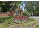 Dunwoody Club Forest brick community sign surrounded by colorful flowers and lush greenery at 5349 Forest Springs Dr, Dunwoody, GA 30338