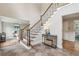Welcoming home entryway with tile flooring, staircase with iron railings, and decorative table at 5349 Forest Springs Dr, Dunwoody, GA 30338