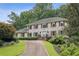 Charming brick home with classic shutters, manicured lawn, and paved driveway leads to an inviting entrance at 5349 Forest Springs Dr, Dunwoody, GA 30338