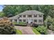 Elegant two-story brick home with a paved driveway, manicured landscaping, and a welcoming front entrance at 5349 Forest Springs Dr, Dunwoody, GA 30338