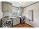 Functional laundry room with modern appliances, storage cabinets, and granite countertops at 5349 Forest Springs Dr, Dunwoody, GA 30338