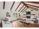 Bright living room boasts hardwood floors, exposed beam ceiling, fireplace and plenty of seating space at 5349 Forest Springs Dr, Dunwoody, GA 30338