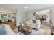 Comfortable living room with hardwood floors, open to dining room and a staircase at 5349 Forest Springs Dr, Dunwoody, GA 30338