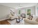 Bright living room with hardwood floors, neutral paint, ceiling fan, and comfortable white sofas at 5349 Forest Springs Dr, Dunwoody, GA 30338