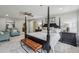 Bright bedroom with large bed, chair seating area, bench and carpet flooring at 5349 Forest Springs Dr, Dunwoody, GA 30338