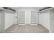 Spacious walk-in closet features carpet flooring, lots of shelf space, and a mini door at 5349 Forest Springs Dr, Dunwoody, GA 30338