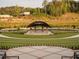 An outdoor amphitheater with lawn seating and covered stage offers a unique venue for entertainment at 630 Skytop Dr # 157, Cumming, GA 30040