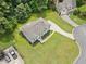 Aerial view showcases the home, its landscaping, driveway and surrounding greenery at 6355 Autumn View Nw Pt, Acworth, GA 30101