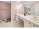 Bathroom with dual sinks, white cabinets, and large mirror at 6355 Autumn View Nw Pt, Acworth, GA 30101