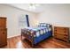Bedroom featuring hardwood floors, a ceiling fan, and two wood dressers at 6355 Autumn View Nw Pt, Acworth, GA 30101