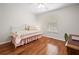 Bright bedroom featuring hardwood floors, a ceiling fan, and a large window at 6355 Autumn View Nw Pt, Acworth, GA 30101