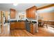 Functional kitchen with granite countertops and wood cabinets, with dining room view at 6355 Autumn View Nw Pt, Acworth, GA 30101