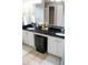 Bathroom featuring double sinks with a dark countertop and white cabinets with storage beneath at 1332 Chandler Cove Way, Grayson, GA 30017