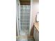 Clean bathroom with tiled floors and a bathtub featuring a patterned shower curtain at 1332 Chandler Cove Way, Grayson, GA 30017