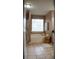 Bright bathroom featuring a large soaking tub, tiled floors, and a window for natural light at 1332 Chandler Cove Way, Grayson, GA 30017