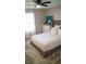 Well-lit bedroom with a neutral color scheme, decorative rug, and a ceiling fan at 1332 Chandler Cove Way, Grayson, GA 30017
