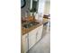 Granite counters in kitchen with updated appliances and white cabinetry at 1332 Chandler Cove Way, Grayson, GA 30017
