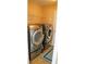 Efficient laundry room featuring modern, front-loading washer and dryer units and a sleek area rug at 1332 Chandler Cove Way, Grayson, GA 30017