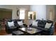 Living room featuring comfortable leather seating and view to the kitchen area at 1332 Chandler Cove Way, Grayson, GA 30017