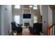 Bright living room boasts a fireplace, large windows, and comfortable leather seating at 1332 Chandler Cove Way, Grayson, GA 30017