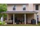 Cozy covered patio featuring comfortable seating, plants, and an inviting outdoor ambiance at 1332 Chandler Cove Way, Grayson, GA 30017