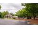 Community pool area with a clubhouse, ample seating, and a well-maintained parking lot at 1332 Chandler Cove Way, Grayson, GA 30017