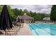 Well-maintained community pool with lounge chairs and a clear view of the clubhouse at 1332 Chandler Cove Way, Grayson, GA 30017