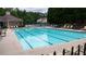 Community pool featuring multiple swimming lanes, seating, and a view of the clubhouse at 1332 Chandler Cove Way, Grayson, GA 30017