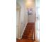 Elegant staircase featuring hardwood steps, railing, and white trim at 1332 Chandler Cove Way, Grayson, GA 30017