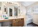 Bathroom features a bathtub, vanity, tile and hardwood floors at 2512 Halcyon Way, Lawrenceville, GA 30044