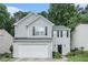 Charming two-story home with light gray siding, black shutters, a two-car garage, and lush landscaping at 2512 Halcyon Way, Lawrenceville, GA 30044