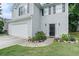 Close-up of a charming home featuring a well-manicured lawn and a welcoming front entrance at 2512 Halcyon Way, Lawrenceville, GA 30044