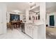 Open kitchen with modern appliances, white cabinets, and seamless flow to dining space at 2512 Halcyon Way, Lawrenceville, GA 30044
