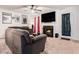 Cozy living room featuring a fireplace, large TV, comfortable seating, and access to the outside at 2512 Halcyon Way, Lawrenceville, GA 30044