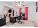 Bright home office with neutral carpet, a ceiling fan and view into den with fireplace at 2512 Halcyon Way, Lawrenceville, GA 30044