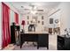 Bright home office with neutral carpet, red curtains, a ceiling fan and view into living room at 2512 Halcyon Way, Lawrenceville, GA 30044