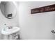 Clean powder room featuring a pedestal sink and decorative mirror at 2512 Halcyon Way, Lawrenceville, GA 30044