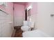 The bathroom has a large mirror, white tile and a modern toilet at 6539 E Strickland St, Douglasville, GA 30134
