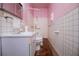 The bathroom has a large mirror, white tile and a modern toilet at 6539 E Strickland St, Douglasville, GA 30134