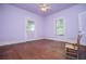 Bright bedroom with wood floors, ceiling fan, window and door leading outside at 6539 E Strickland St, Douglasville, GA 30134